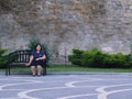 Alone sitting woman on a bench