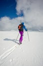 Alone skier walking through the untouched snow Royalty Free Stock Photo