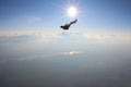 Alone skydiver is falling in the sky above skyline. Royalty Free Stock Photo