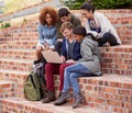 Alone we are smart, together we are brilliant. a group of students sitting outside while on campus. Royalty Free Stock Photo