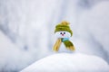 Alone snowman in nice hat and scarf with red nose. Royalty Free Stock Photo