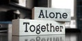 Alone, together - words on wooden blocks