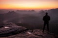 Alone tourist in black waiting for morning sun in mountains Royalty Free Stock Photo