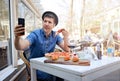 Alone tourist man taking selfie and eating a slice of pizza