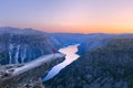 Alone tourist on Trolltunga rock - most spectacular and famous scenic cliff in Norway Royalty Free Stock Photo