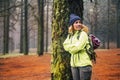 Alone woman with cold and winter clothes enjoy the outdor leisure activity in the forest the forest with trees - vacation and trip