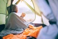 Alone Woman drinks hot tea in camping tent and enjoy with autumn