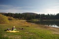 Alone woman with a picnic sitting by the lake