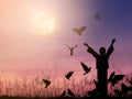 Alone woman praying and free bird flying to the dramatic sky background Royalty Free Stock Photo