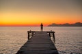 Alone women relax on wooden dock at peaceful lake, silhouette Royalty Free Stock Photo