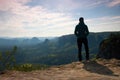 Alone young girl tourist enjoy morning on sandstone rock and watch over valley to Sun. Royalty Free Stock Photo