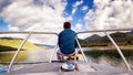 Alone young man relax siting on boat thinking and concentrating