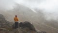 Alone young woman looking at the landscape of the Cayambe volcano near the Ruales Oleas Berge refuge