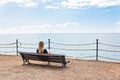 Alone young woman sitting on the bench