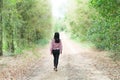 Alone Young Women Walking on Road Away in Forest at Countryside Grill on Path Way in Park Landscape,Concept for Broken Heart or Royalty Free Stock Photo