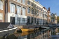 Along the Hooigracht in The Hague there are beautiful houses and many boats, some of which have partly sunk, along the quay Royalty Free Stock Photo