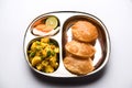 Aloo Fry OR Bombay potatoes and puri/Poori in a stainless steel oval plate Royalty Free Stock Photo