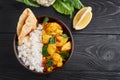 Aloo gobi with rice and chapati. Indian cuisine vegetarian dish. decorated with lemon and cauliflower