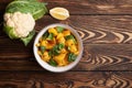 Aloo gobi with rice and chapati. Indian cuisine vegetarian dish. decorated with lemon and cauliflower