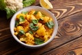 Aloo gobi with rice and chapati. Indian cuisine vegetarian dish. decorated with lemon and cauliflower