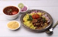 Aloo/Kanda Poha or Tarri Pohe with spicy chana masala/curry. Served in ceramic plate.