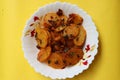 Aloo Katli or Potato Katli is an excellent and tasty asian dish, slices of fried potatoes, sauces and herbs, snack or starter Royalty Free Stock Photo