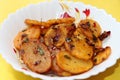 Aloo Katli or Potato Katli is an excellent and tasty asian dish, slices of fried potatoes, sauces and herbs, snack or starter Royalty Free Stock Photo