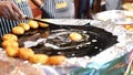 Aloo tikki being beep fried in a pan , also known as aloo ki tikkia, aloo ki tikki or alu tikki, is a snack originating from the