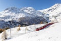 Red train from Rhaetian Railway is passing the train tracks with tight 180ÃÂ° curve Royalty Free Stock Photo