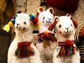 Alpaca plush toys ornated with rainbow-colored bows, Pisac traditional market, Peru