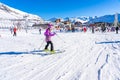 ALPE D'HUEZ, FRANCE - 31.12.2021:Girl skiing in the Alpine mountains with white snow and blue sky. People Skier