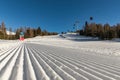 Dolomites, ski area with beautiful slopes and blue sky. Empty ski slope in winter on a sunny day. Prepare ski slope, Alpe di Lusia Royalty Free Stock Photo