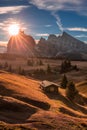 Alpe di Siusi, Italy - Autumn sunrise with a wooden chalet at Seiser Alm in South Tyrol in the Dolomites mountain range Royalty Free Stock Photo