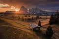 Alpe di Siusi, Italy - Golden autumn sunrise with a wooden chalet at Seiser Alm in South Tyrol province in the Dolomites Royalty Free Stock Photo