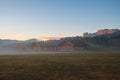 Alpe di Siusi Seiser Alm alpine meadow with beautiful sunrise in the background with the Sassolungo and Langkofel mountains Royalty Free Stock Photo