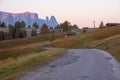 Alpe di Siusi Seiser Alm alpine meadow with beautiful sunrise in the background with the Sassolungo and Langkofel mountains Royalty Free Stock Photo