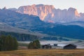 Alpe di Siusi Seiser Alm alpine meadow with beautiful sunrise in the background with the Sassolungo and Langkofel mountains Royalty Free Stock Photo