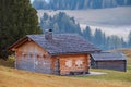 Alpe di Siusi Seiser Alm alpine meadow with beautiful sunrise in the background with the Sassolungo and Langkofel mountains Royalty Free Stock Photo