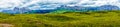 Alpe di Siusi, Seiser Alm with Sassolungo Langkofel Dolomite, a large green field with a mountain in the background panorama Royalty Free Stock Photo