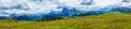 Alpe di Siusi, Seiser Alm with Sassolungo Langkofel Dolomite, a large green field with a mountain in the background panorama Royalty Free Stock Photo