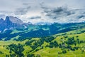 Alpe di Siusi, Seiser Alm with Sassolungo Langkofel Dolomite, lush green field in Seiser Alm Puflatsch Bullaccia