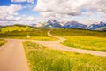 Alpe di Siusi, Seiser Alm with Sassolungo Langkofel Dolomite, a trekking walking winding path parting split Royalty Free Stock Photo