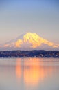 Alpenglow on Mount Rainier reflects on Puget Sound