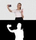 Smiling attractive woman taking a selfie while walking, Alpha Channel Royalty Free Stock Photo