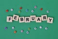 Alphabet beads and square letters with text text FEBRUARY