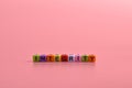 Alphabet beads with text INTEGRITY isolated on pink background