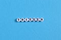 Alphabet beads with text TRIGGER isolated on blue background