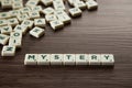 Alphabet block with Mystery word wooden table Royalty Free Stock Photo