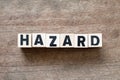 Alphabet block in word hazard on wood background