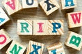 Alphabet block in word RIP abbreviation of rest in peace with another on wood background